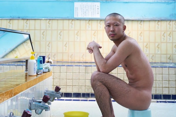 color portrait photograph of a Japanese man in sento bath house in tokyo, japan by Simon Urwin