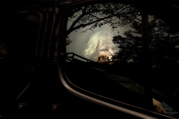 Street photography by Camilla Ferrari, woman, reflection, trees