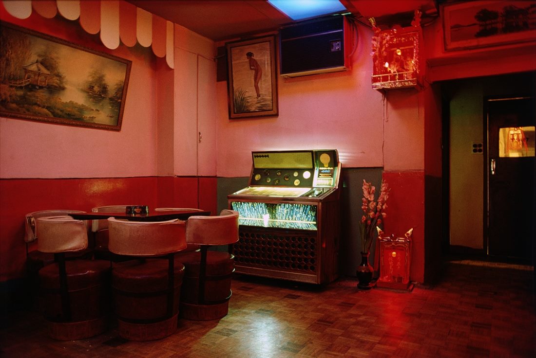 Color analog photography by Greg Girard. Red interior of Hong Kong bar, 1980s