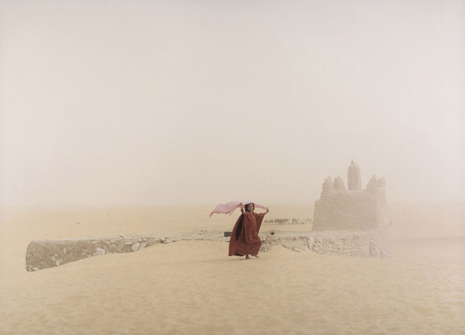 Color photography person with red clothes in desert Mali