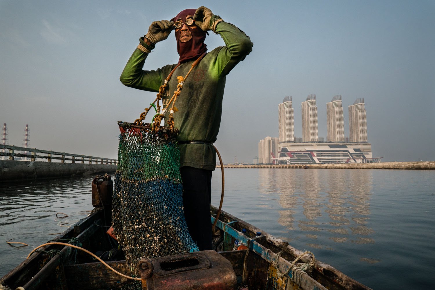 Kristof Vadino, documentary photography, visual storytelling. Alex, 41, mussel fisherman, lives with his wife and two daughters in a cabin by the sea in North Jakarta, Indonesia.