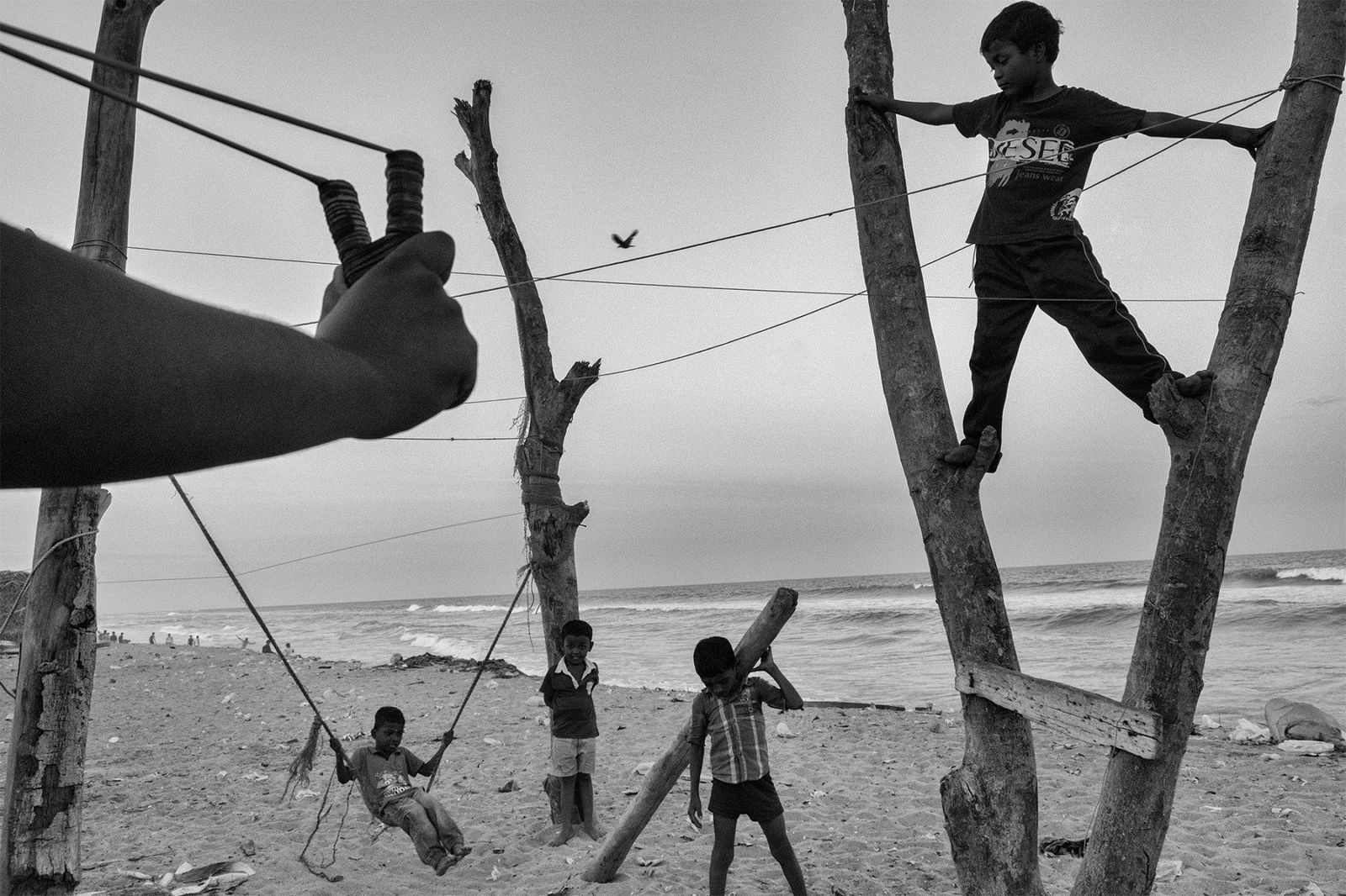 Black and white photo by Sasikumar Ramachandran, children playing on the beach, Chennai, India