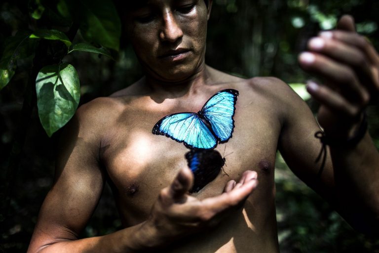 Portrait image by of a man and a butterfly in Peru, South America. Photograph by Javier Arcenillas - People & Photography