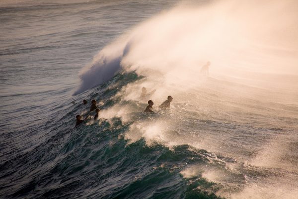 Travel photograph by Alexander Smiley of surfers riding waves at Bronte beach, Australia