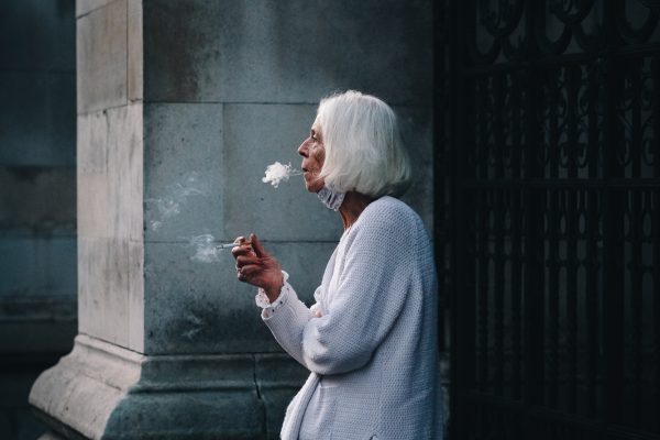 Color street photography by Francesco Gioia, woman smoking