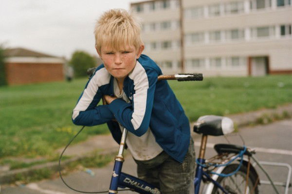 Color film photography by Laura Pannack young boy, youth on bike