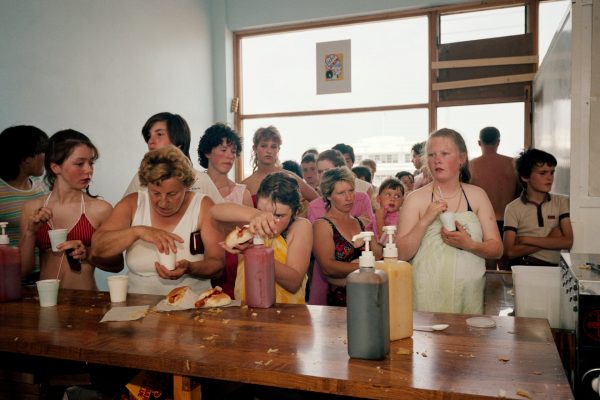 Color photo by Martin Parr, People queue for tea and hot dogs. From The Last Resort 1983-85