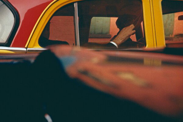 Color photo by Saul Leiter, yellow and red taxi, NYC