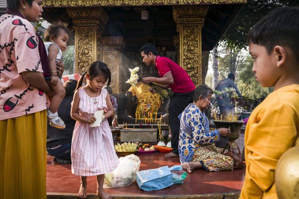 street color photograph of people at a Buddhist temple shot in Siem Reap, Cambodia by Florian E. J. Lang