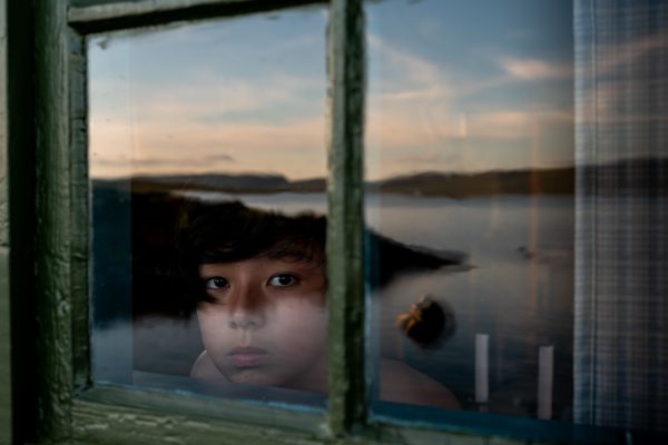 color portrait of a young boy with sky reflection by Junko Akita