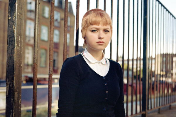 medium format analog color portrait of a skinhead girl in London, UK by Owen Harvey