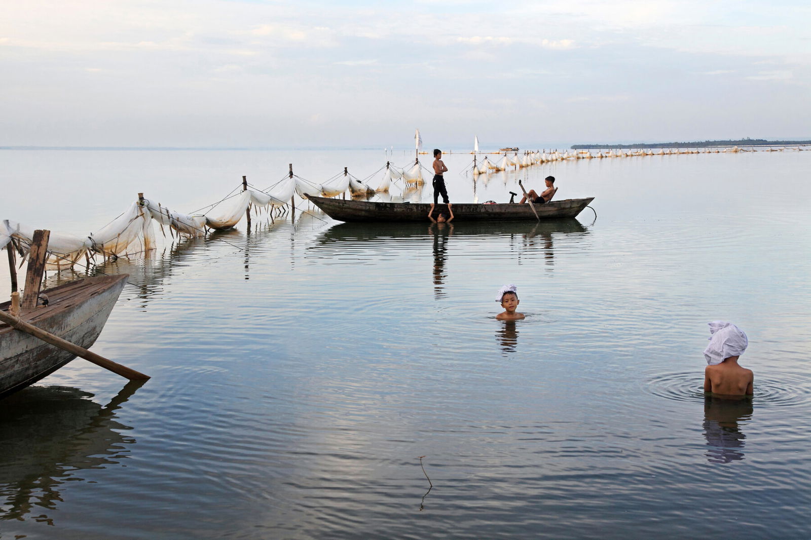 color photograph of children swimming in a the Mekong Delta, Vietnam