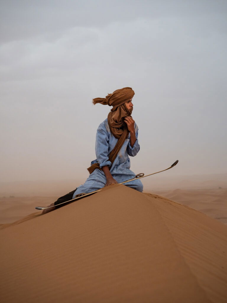 color portrait photo of man on sand dunes by Joan Morse