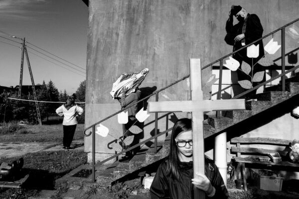 black and white street photo of people in Poland by Szymon Lewinski