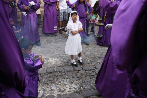 color street photo of a girl in white dress in Antigua, Guatemala by Maude Bardet