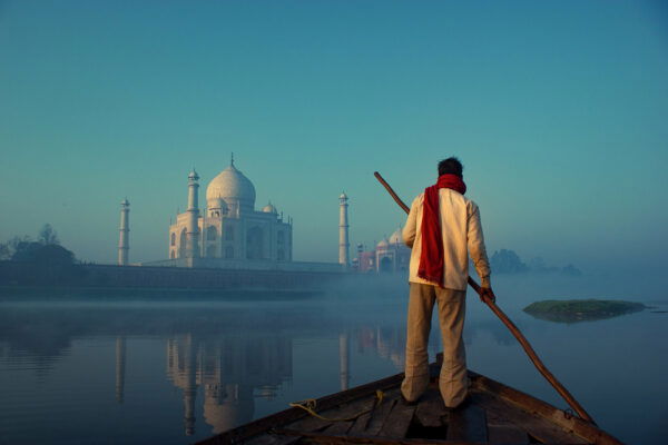 color photograph of a man in front of Taj Mahal