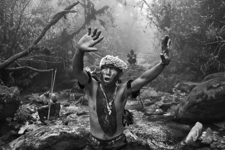 Black & White photography by Sebastião Salgado, a Yanomami shaman performs a ritual in Amazonias, amazon rainforest Brazil. From the exhibition Amazonia