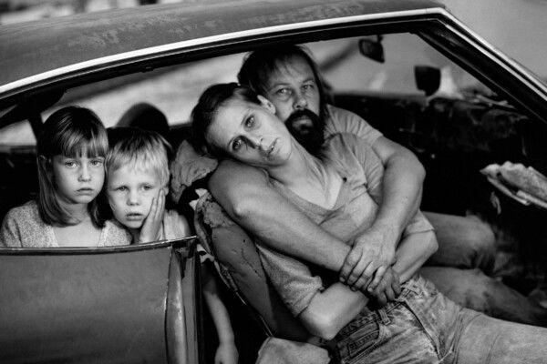 Black and white documentary photography by Mary Ellen Mark. Family in their car. From the article The Bestr Portrait Photographers of all time.