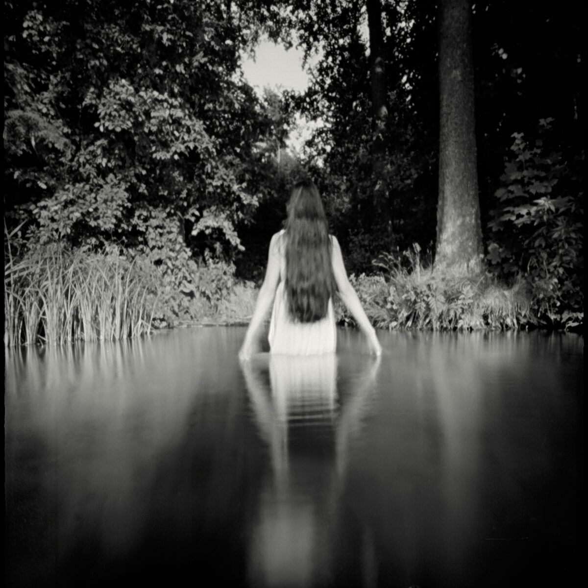 black and white film photo of a woman in water by Joanna Borowiec