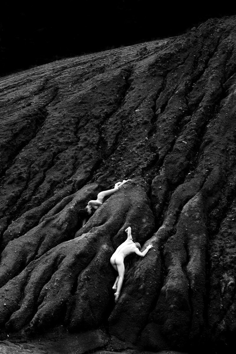 fine art black and white photo of woman and man in landscape by Alana Cartwright