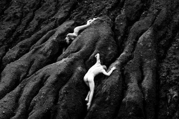 fine art black and white photo of woman and man in landscape by Alana Cartwright