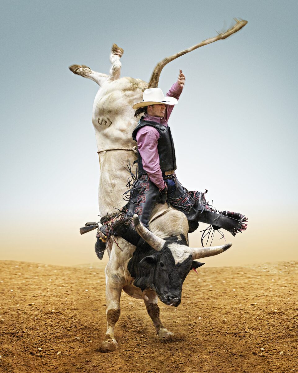 color photo of man on bull at rodeo in Mesquite, Texas, USA by Steve Wrubel