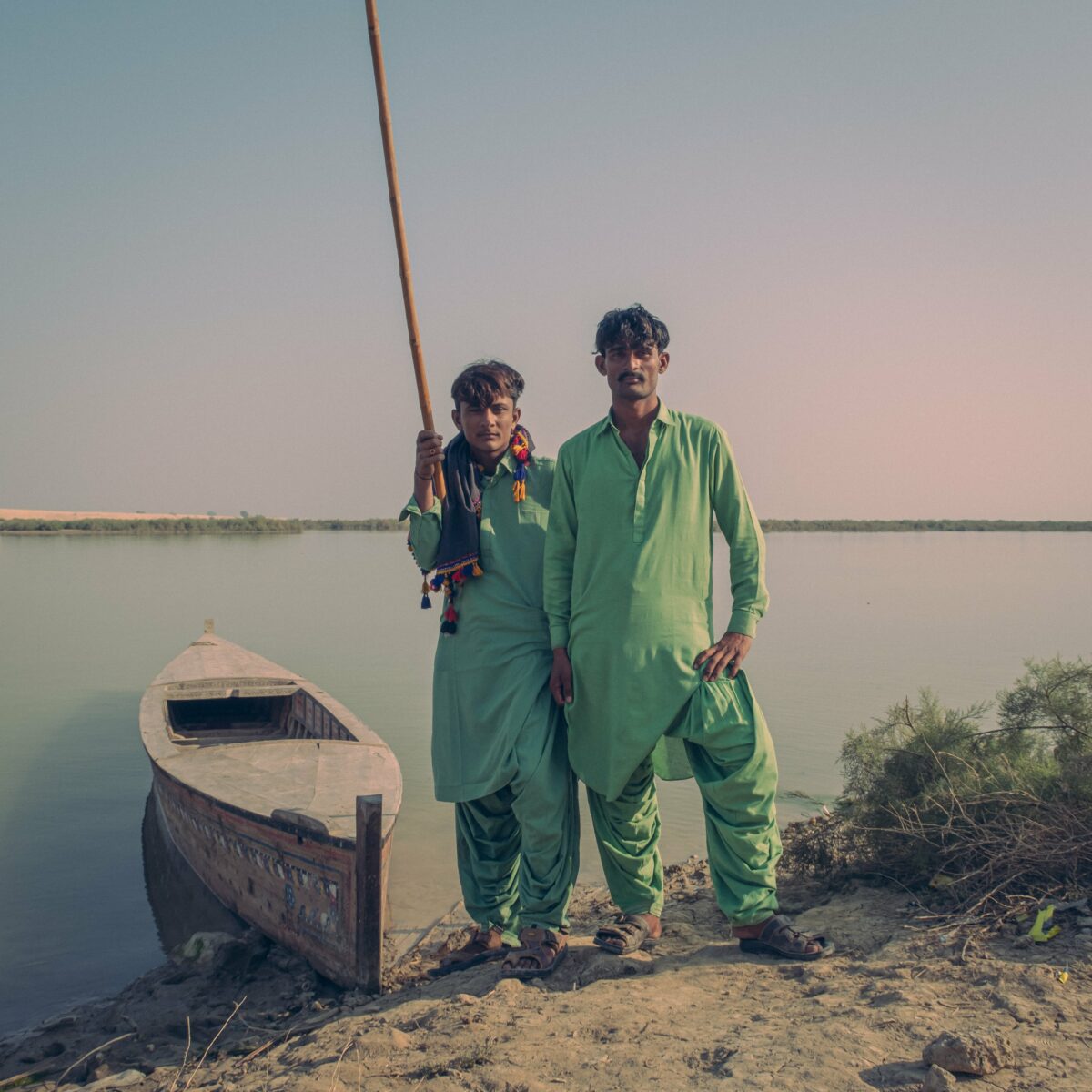 Color portrait of two men in front of lake, India, Gauthier Digoutte