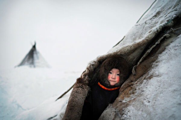 color portrait photo of a youn Nenet in front of his chum in Siberia by Tommaso Vecchi