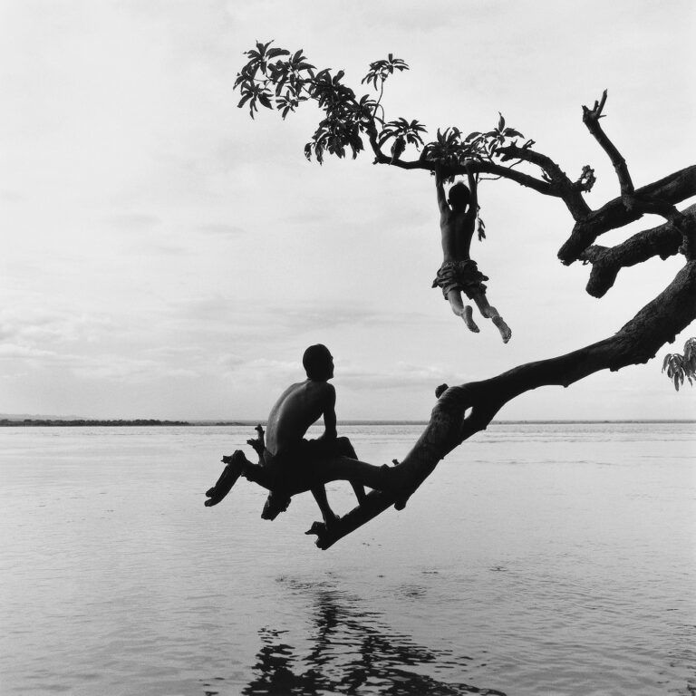 Black & white portrait photography by Monica Denevan, boys playing on trees, Burma