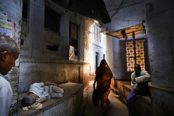 color street photo of people in streets of varanasi, india by Alain Schroeder