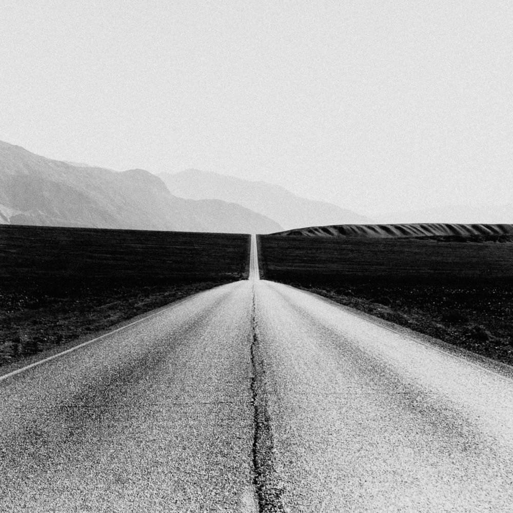 Black & white landscape photography by Adrian Vila. Road and mountains