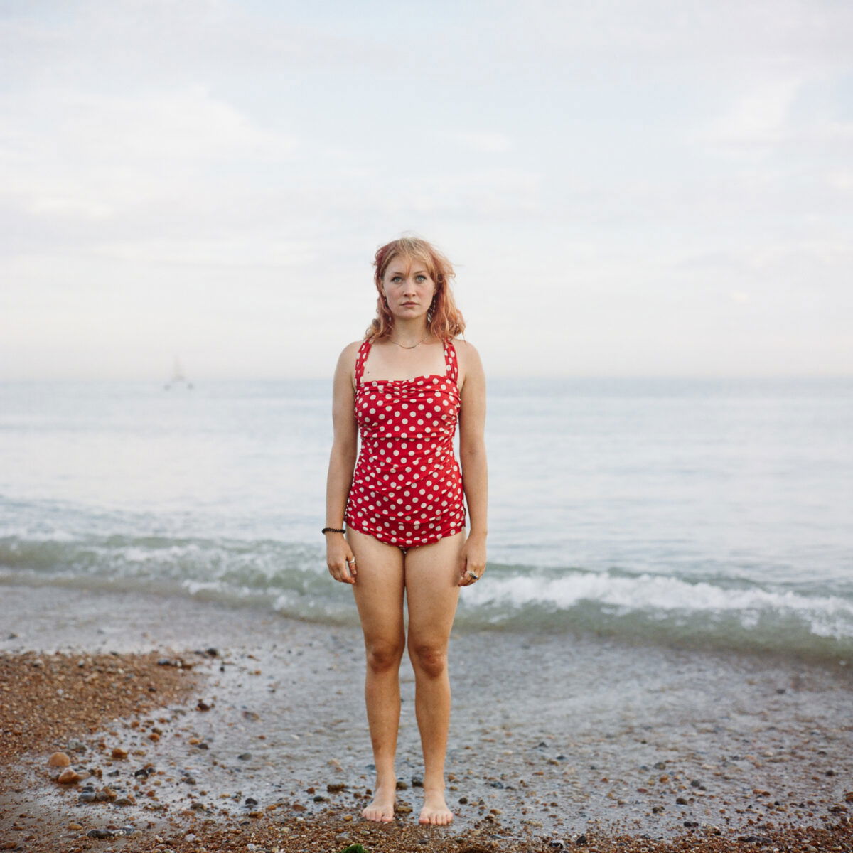 color medium format film portrait of a woman wearing bathing sun by the sea by Andreas Bleckmann