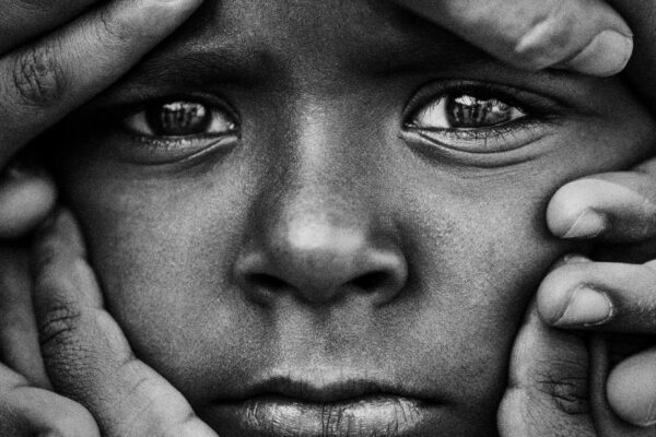 black and white close up portrait of an Indian child in Bangalore, India by Devanshu Damle