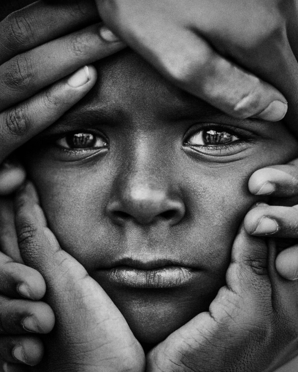 black and white close up portrait of an Indian child in Bangalore, India by Devanshu Damle