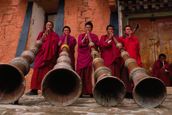 Photo of monks blowing large horns by Michael Yamashita