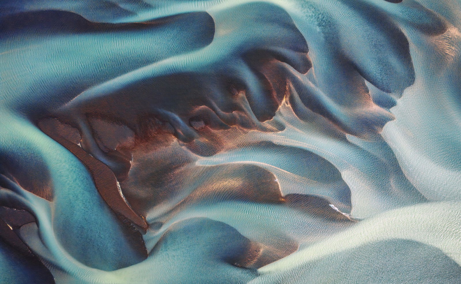 aerial drone color landscape photo of icelandic river by Phillip Glombik