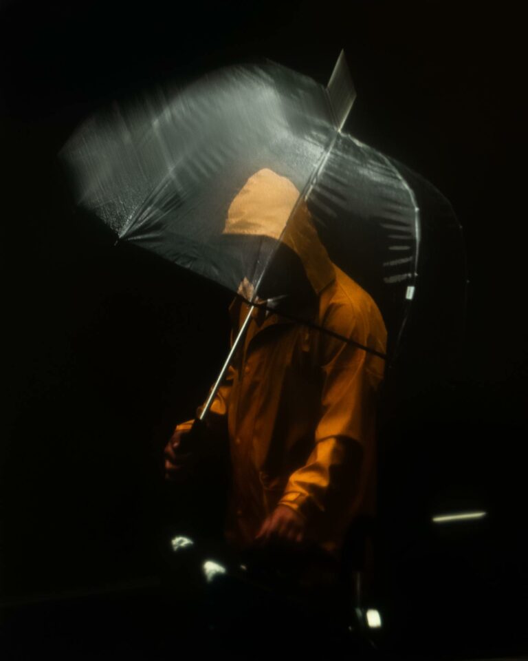 Street photography by Joe Clarke. Man with umbrella.