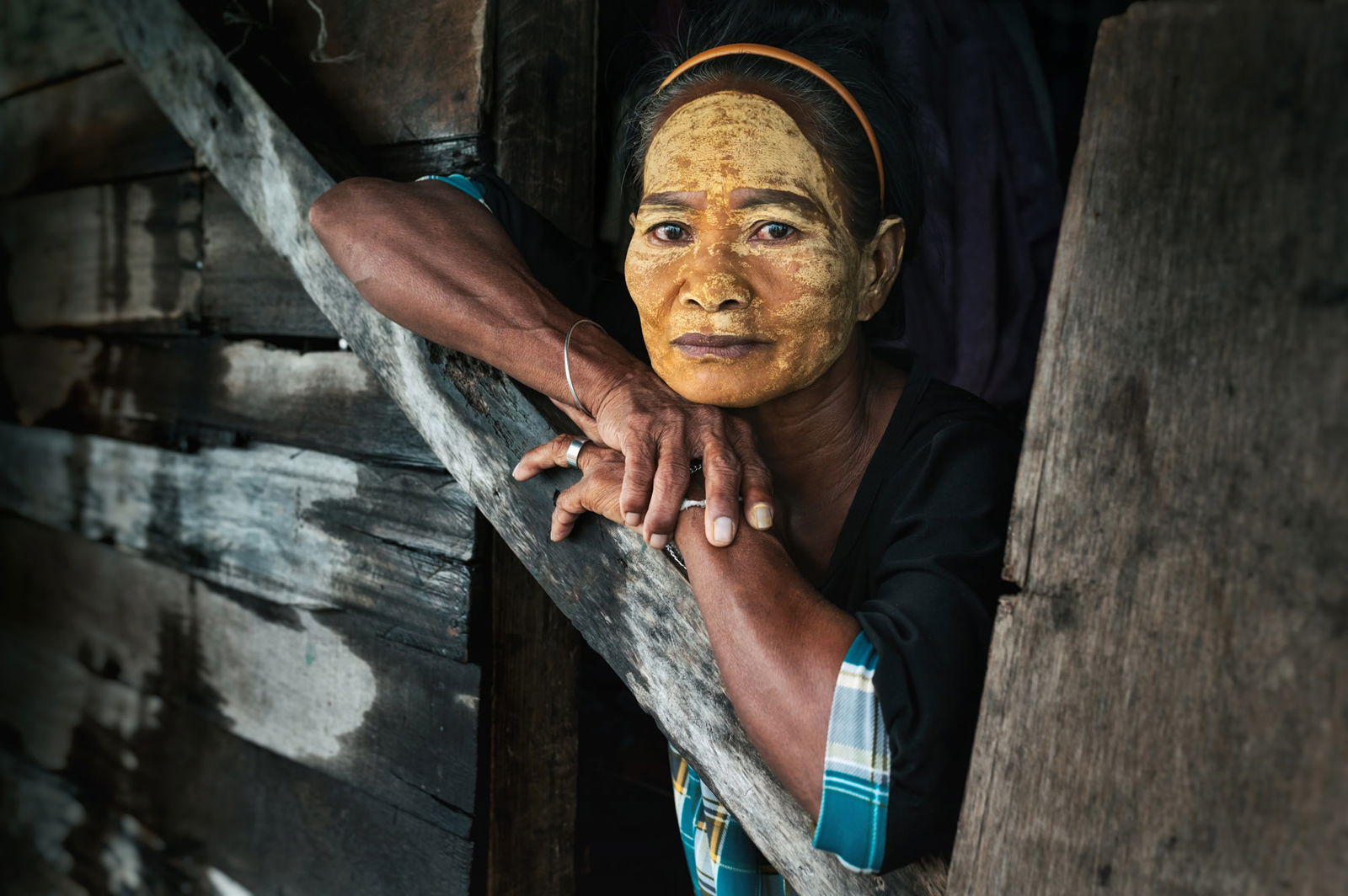 Portrait of a Bajau woman with her face painted yellow by Jacopo Della Valle