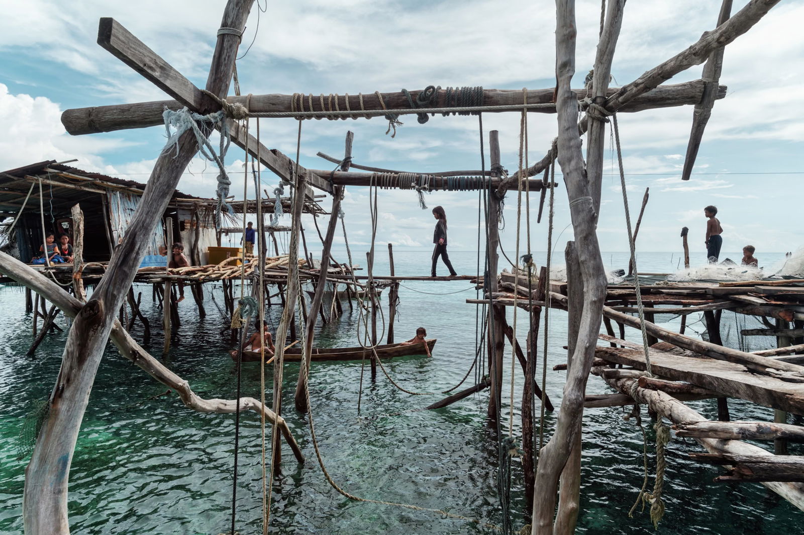 Documentary photography by Jacopo Della Valle. Photo of wooden stilt houses in the ocean