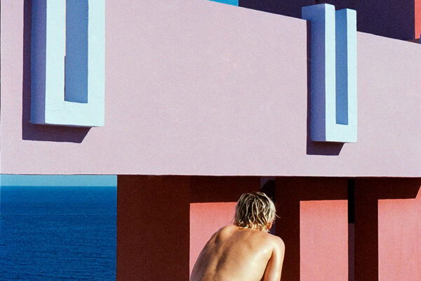 color portrait of man in swim shorts with architecture landscape by Daniela Muttini