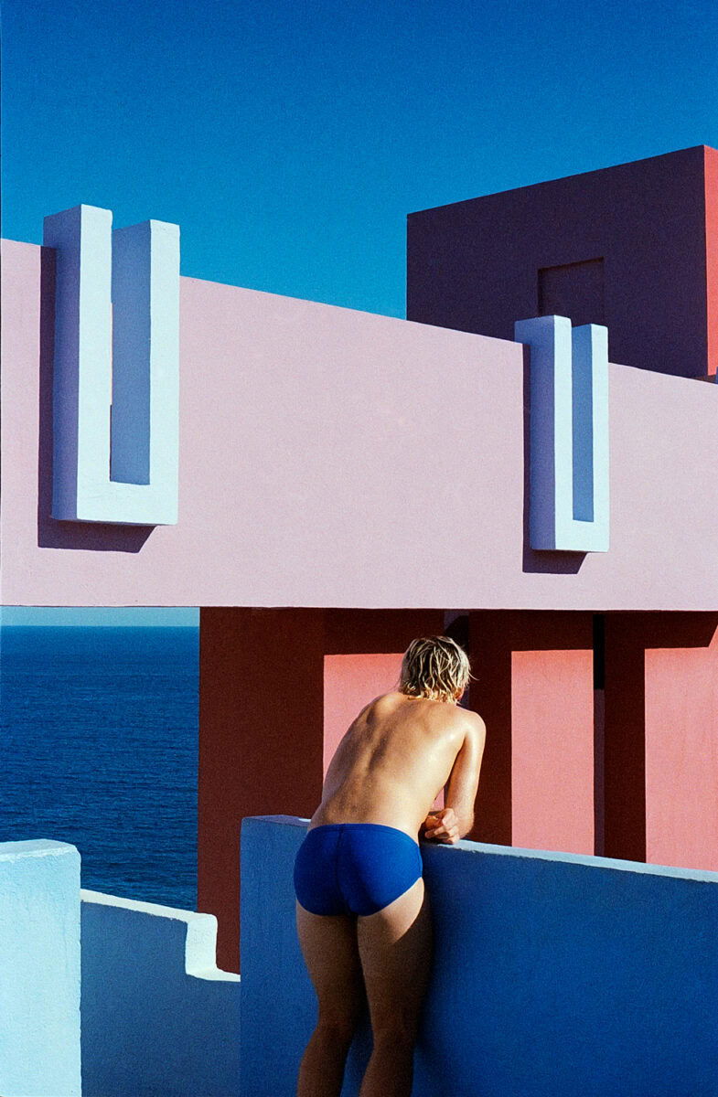 color portrait of man in swim shorts with architecture landscape by Daniela Muttini