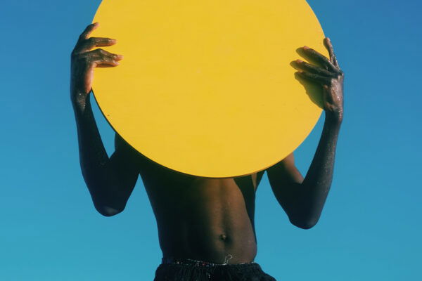 color portrait photo of kid holding yellow disc by Ernesto Sumarkho