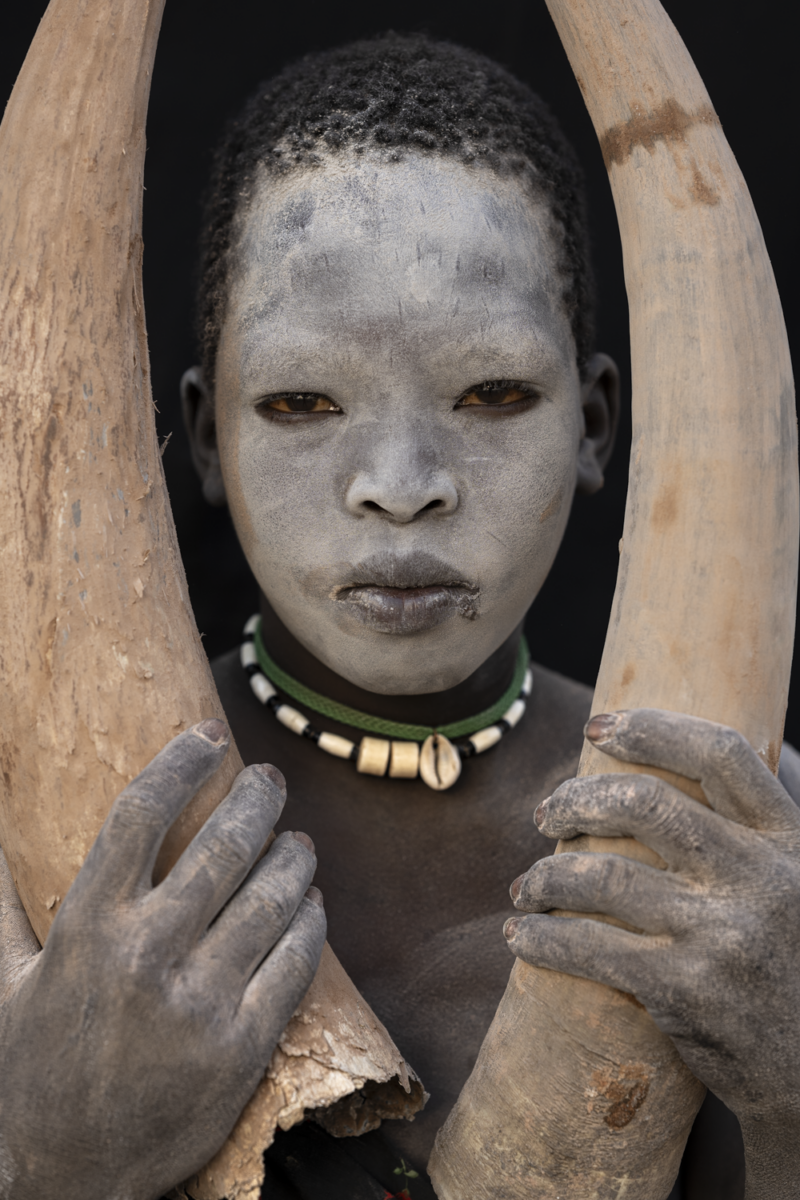 color fine art portrait of mundari boy by Maricruz Sainz De Aja