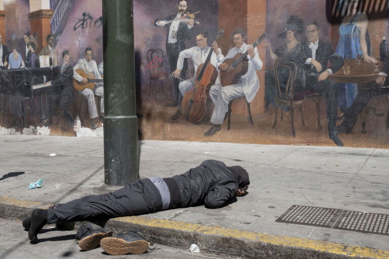 A photo of a man lying on a street by Søren Bidstrup