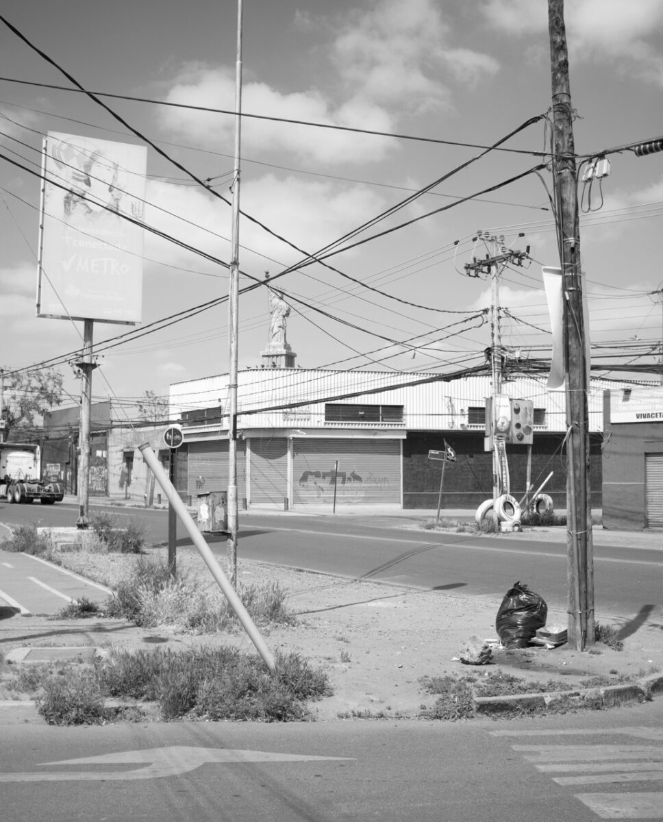 Black & white photo of street with lots of power lines by Juan Miguel Ramírez-Suassi