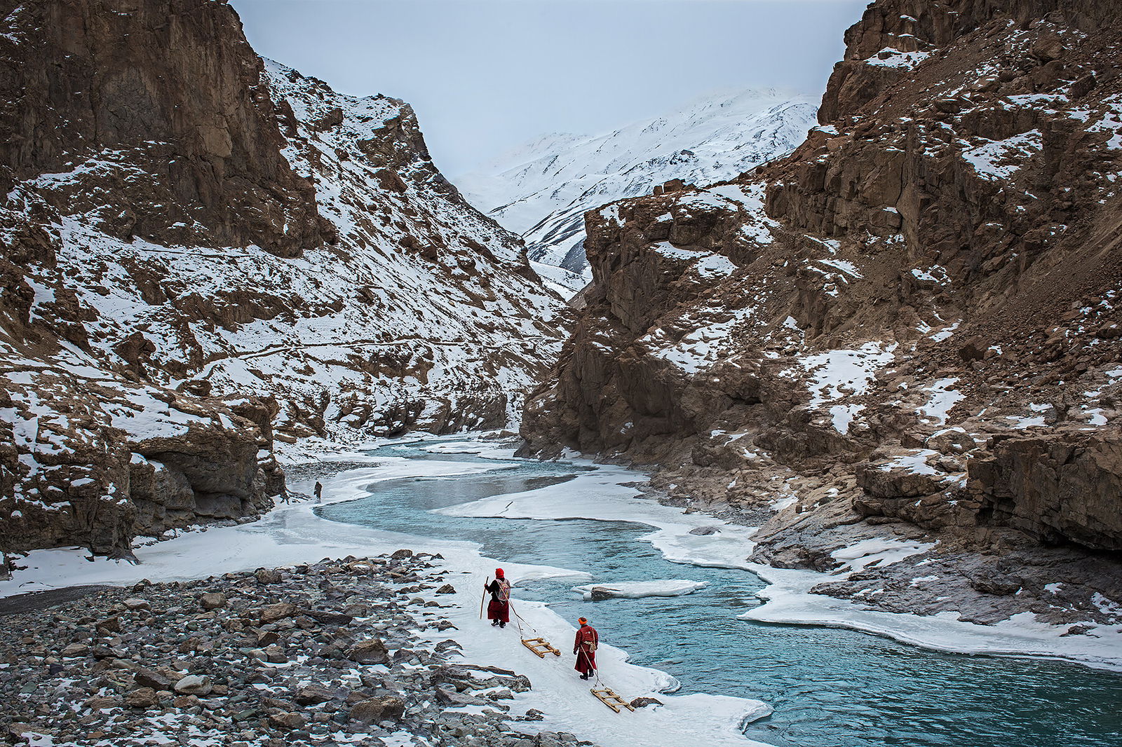 color photo of men carrying supplies for Phugtal Monastery, - Ladakh, Northern India by Andrew Newey