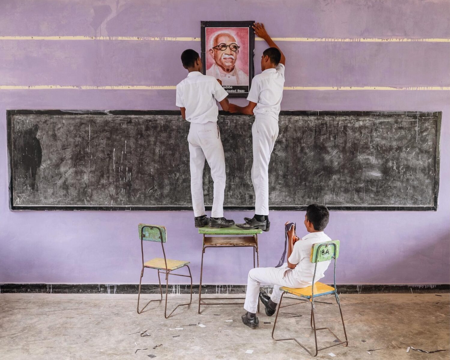 color photo of three boys in classroom in Sri Lanka by Pie Aerts