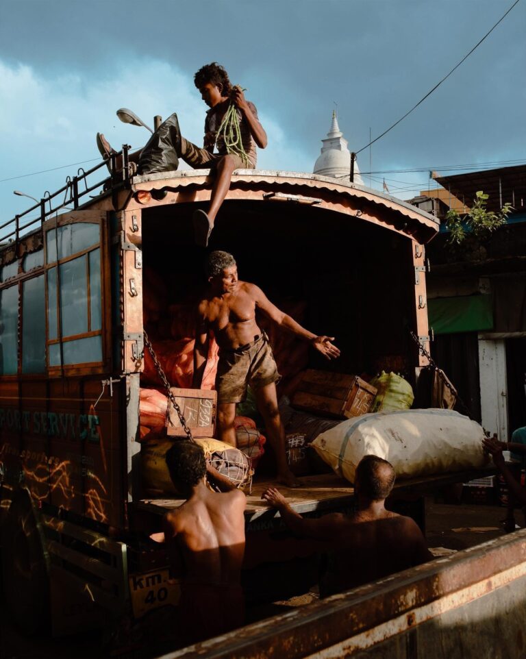 color street photo of people loading a truck in Sri Lanka by Pie Aerts