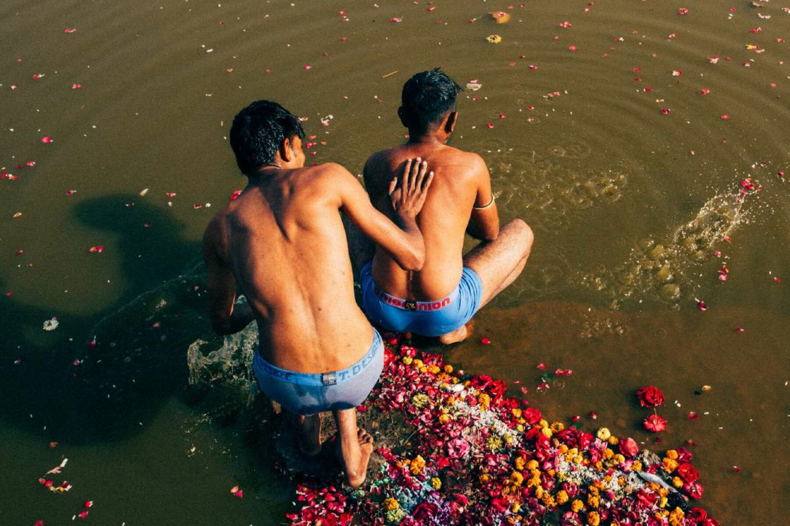 Photo of two men bathing in the ganges by Pie Aerts