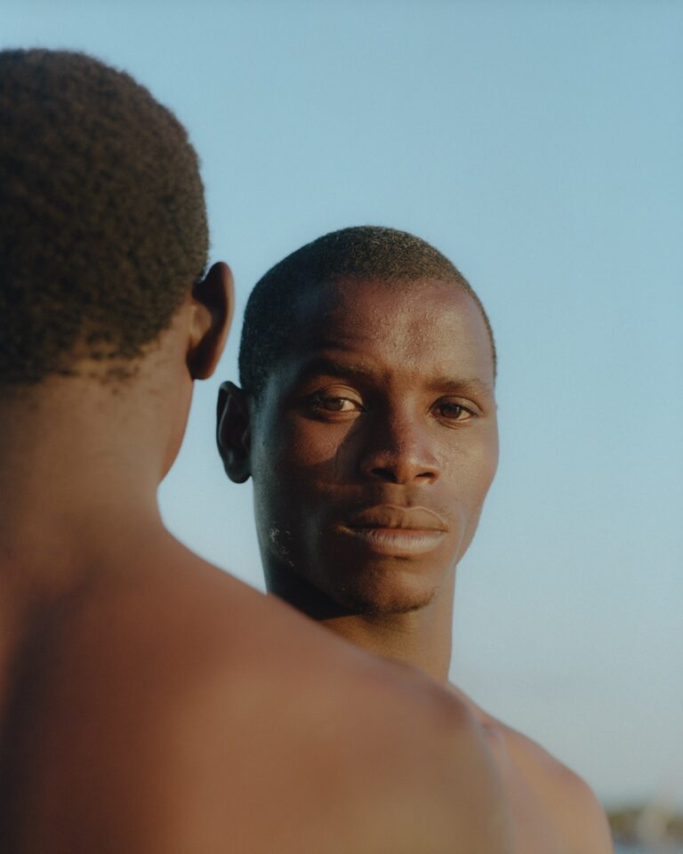 Close up portrait of a the back of one man's head and another facing the camera by Pie Aerts